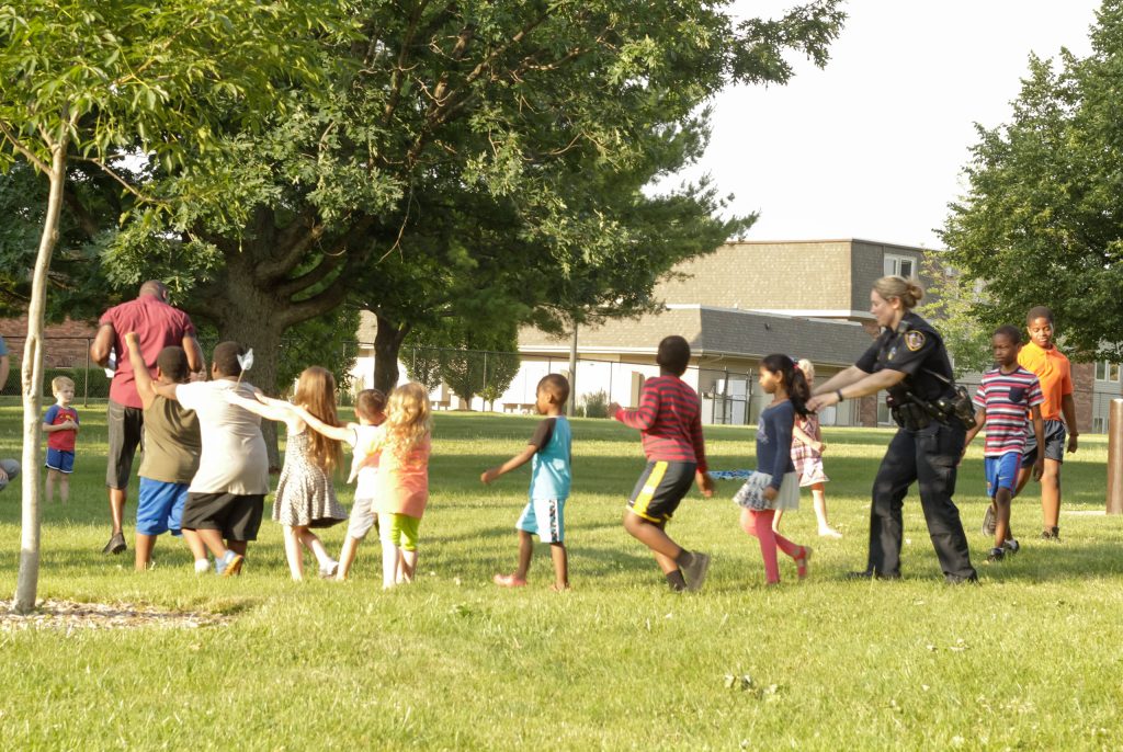 Police Officer playing with group of children